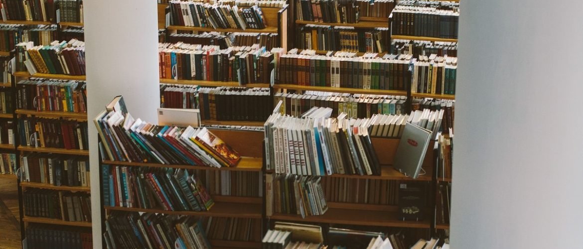 Library shelves full of books and journals, reflecting the team science behind Ward Pettibone's sleep research publications