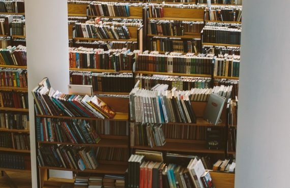 Library shelves full of books and journals, reflecting the team science behind Ward Pettibone's sleep research publications